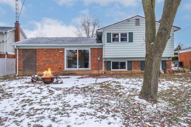 snow covered property featuring a fire pit