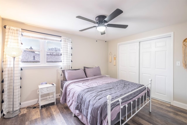 bedroom with dark wood-type flooring, a closet, and ceiling fan