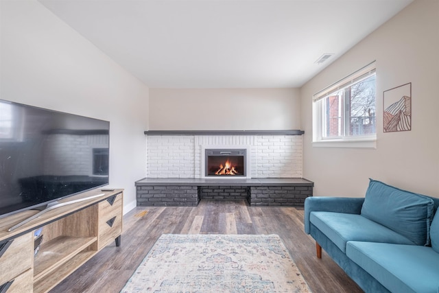 living room featuring a fireplace and dark hardwood / wood-style flooring