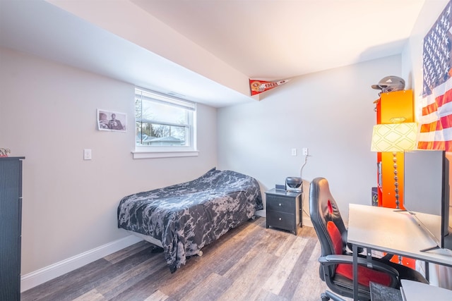 bedroom with dark hardwood / wood-style floors