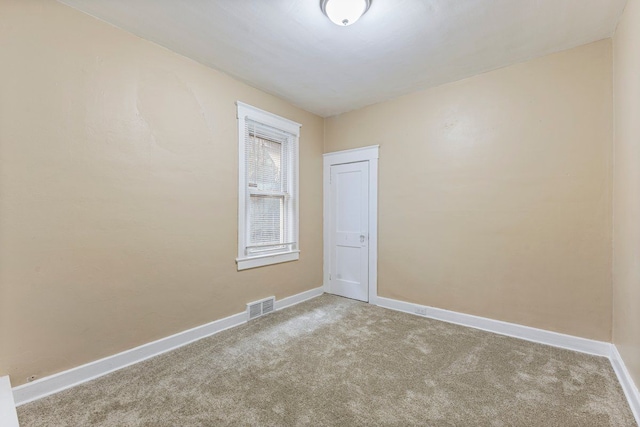 unfurnished room featuring light carpet