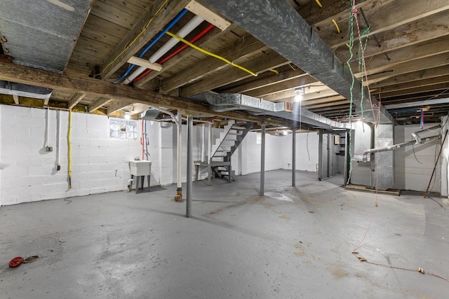 basement featuring sink and heating unit