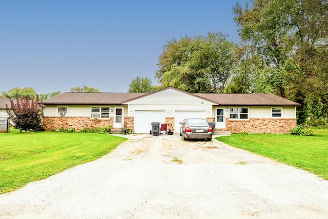 ranch-style house with a garage and a front lawn