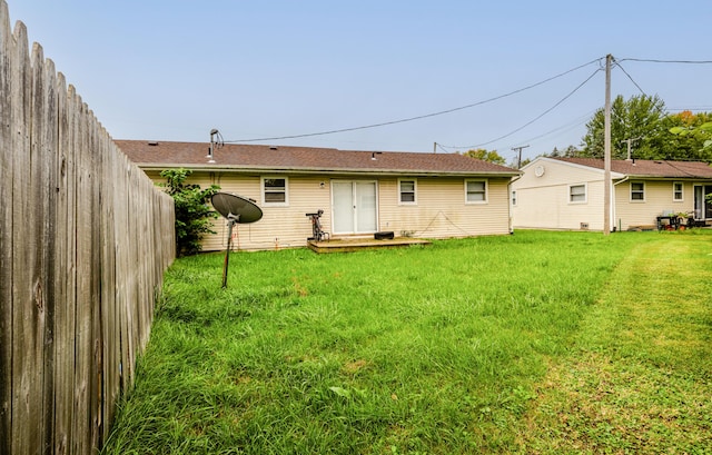 back of house featuring a yard