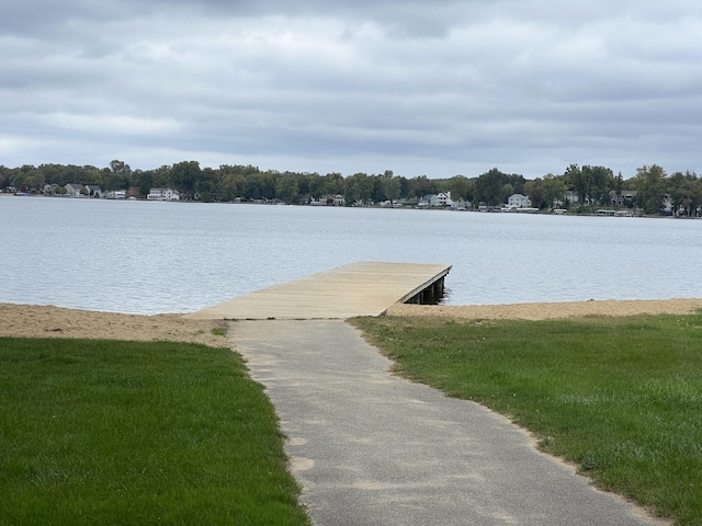 dock area featuring a water view and a yard