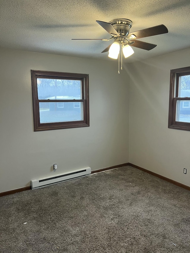 spare room with ceiling fan, a baseboard heating unit, a textured ceiling, and carpet flooring