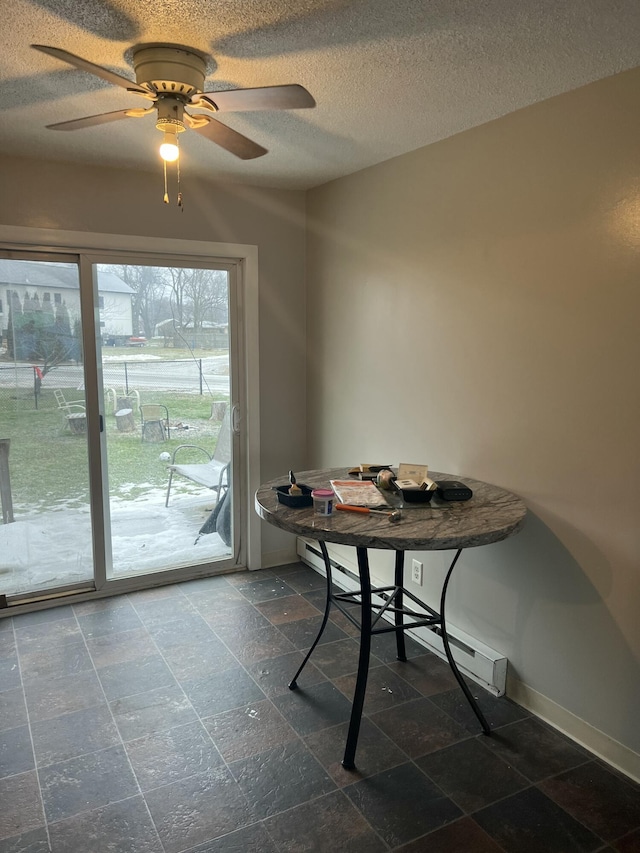 dining area featuring ceiling fan and a textured ceiling