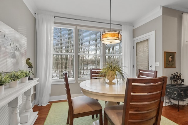 dining room featuring ornamental molding and dark wood-type flooring