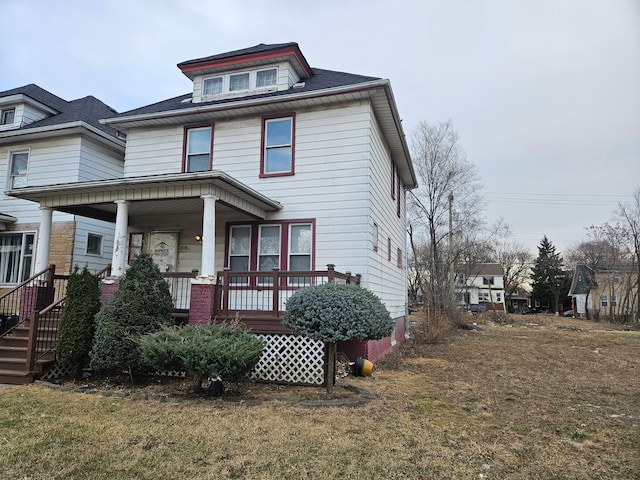 view of front of home with a front yard and covered porch