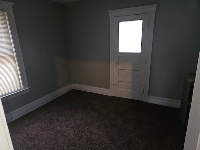 interior space featuring dark colored carpet