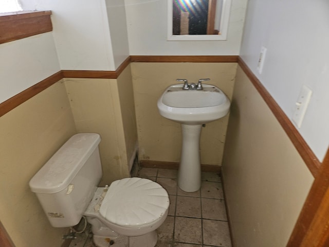 bathroom with tile patterned floors and toilet