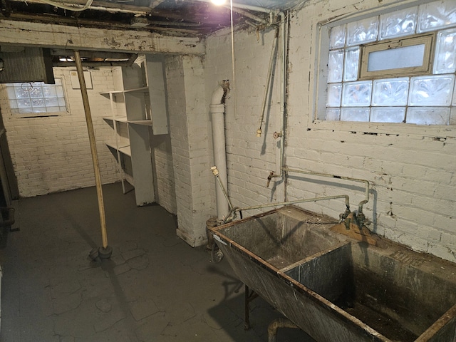 basement with brick wall and sink