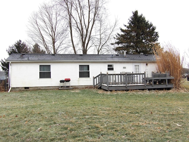 rear view of property with a lawn and a deck