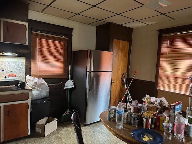 kitchen with stainless steel fridge and a paneled ceiling