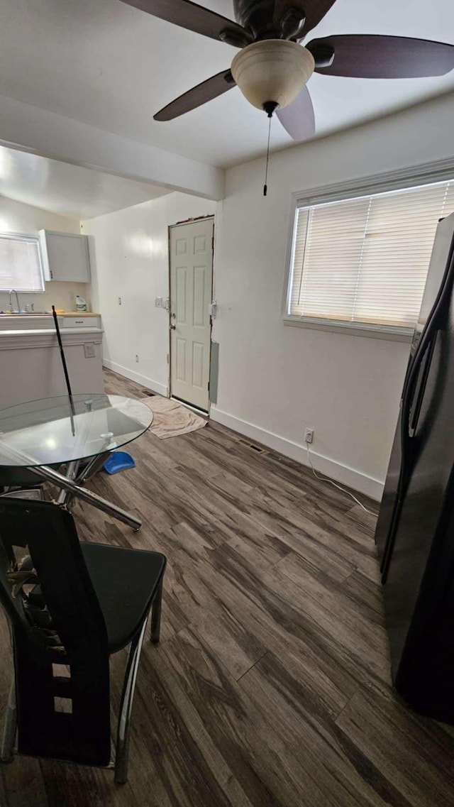 misc room with dark wood-type flooring, ceiling fan, and sink