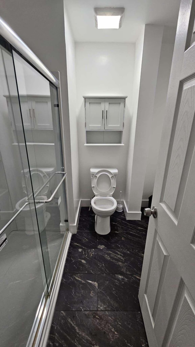 bathroom with toilet and walk in shower