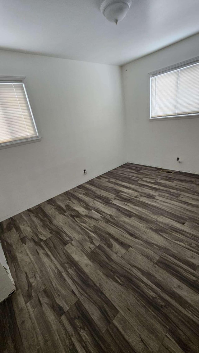 spare room featuring dark hardwood / wood-style flooring