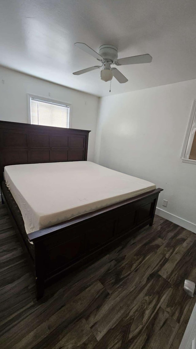 bedroom with ceiling fan and dark hardwood / wood-style flooring