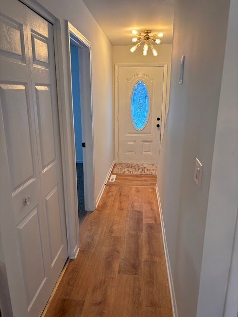 doorway with hardwood / wood-style flooring