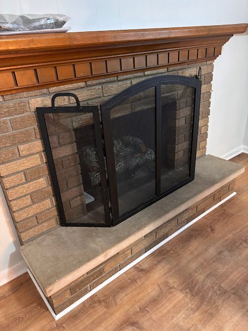 interior details featuring wood-type flooring and a fireplace