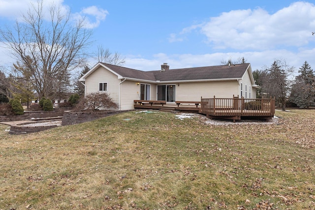 back of property with a wooden deck and a lawn