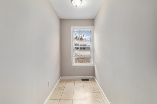 unfurnished room featuring light tile patterned floors