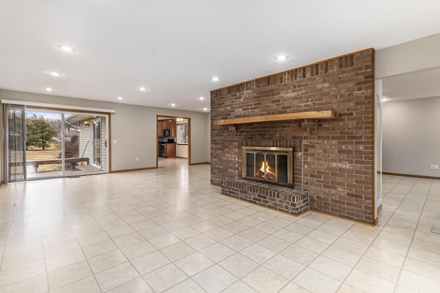 unfurnished living room featuring a brick fireplace and light tile patterned flooring