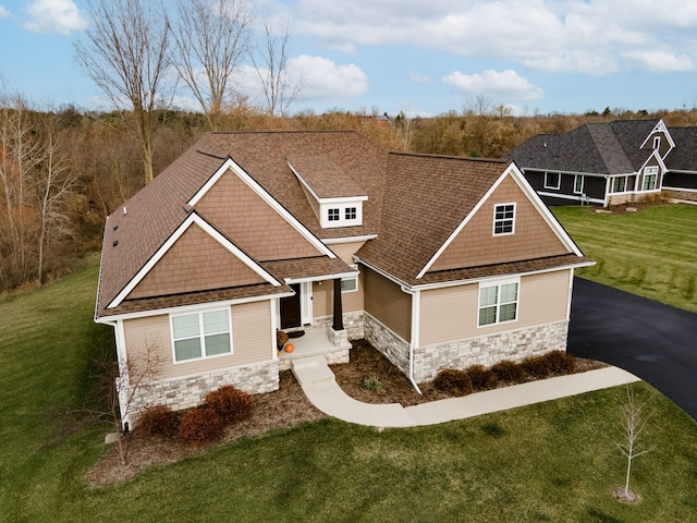 craftsman inspired home with a front lawn