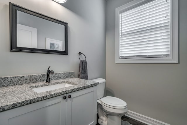 bathroom featuring vanity and toilet