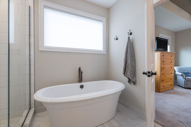 bathroom with a tub to relax in