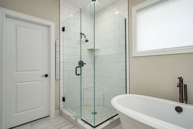 bathroom featuring shower with separate bathtub