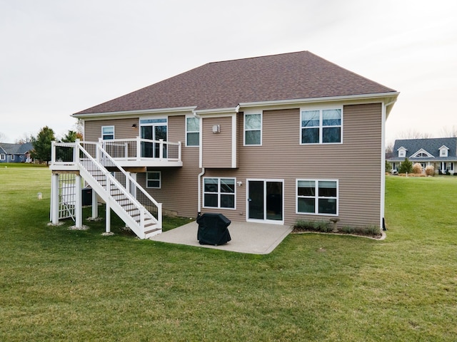 rear view of property with a yard and a patio area