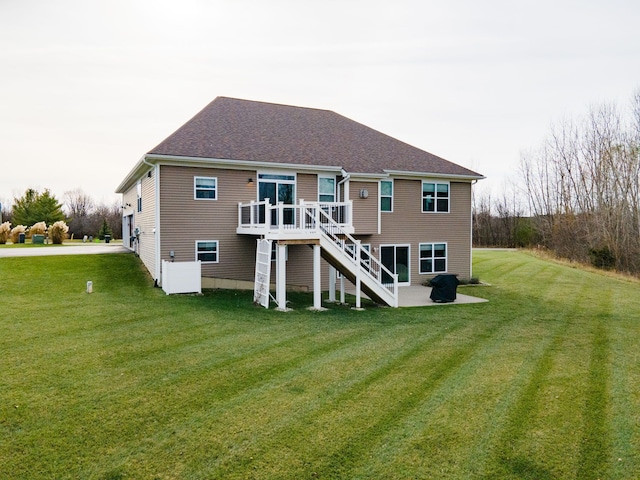 rear view of property featuring a yard and a deck