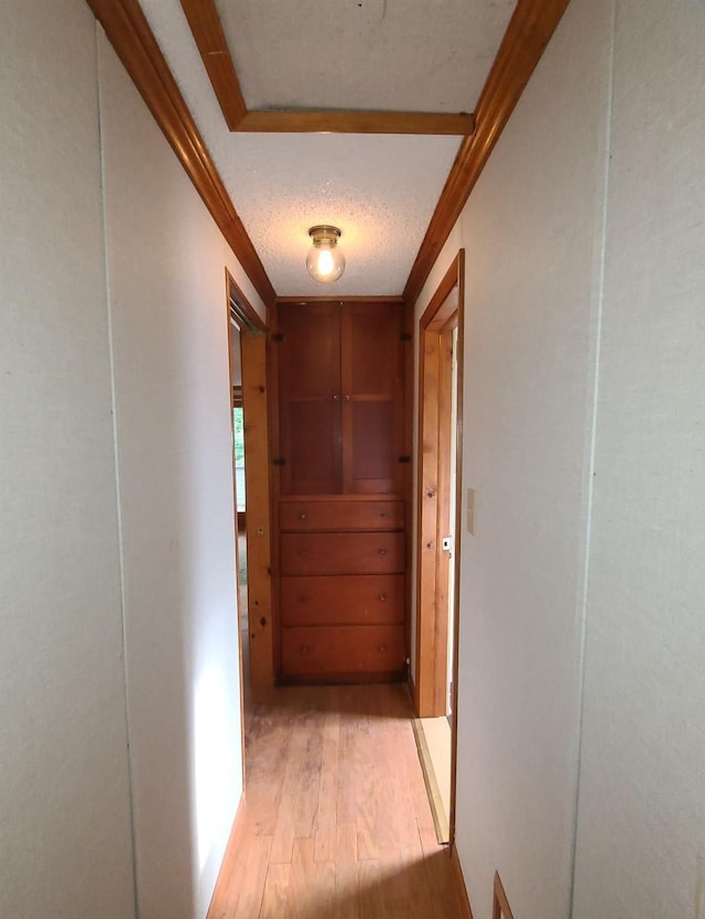 hall featuring light hardwood / wood-style floors and a textured ceiling