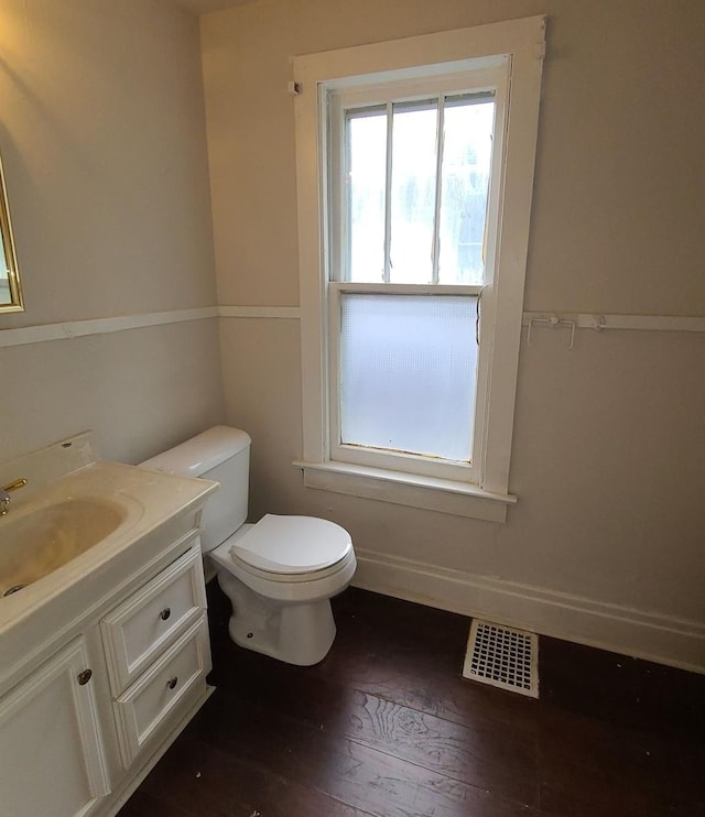 bathroom with vanity, hardwood / wood-style floors, and toilet