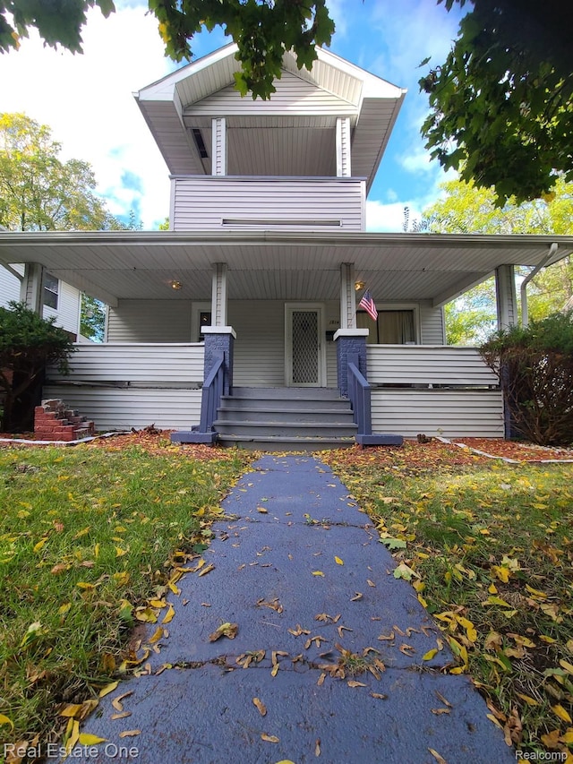 view of front of house with a front lawn and a porch