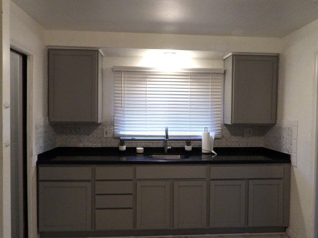 kitchen featuring gray cabinets and sink