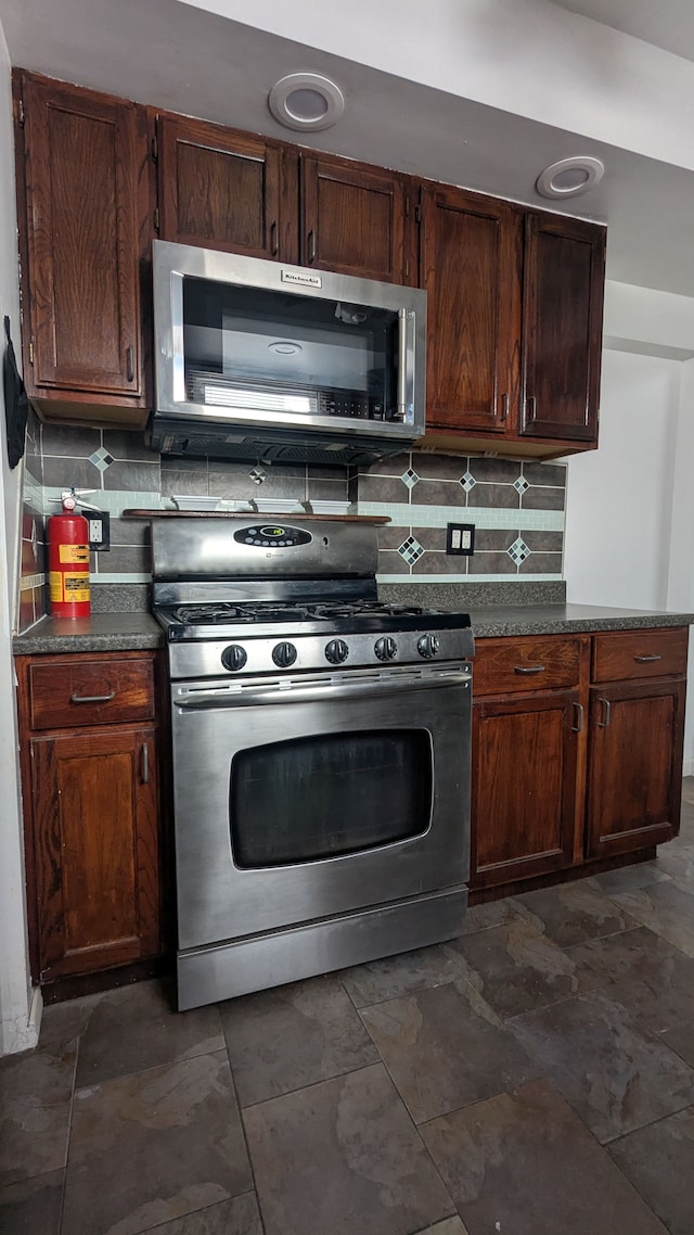 kitchen featuring tasteful backsplash, dark brown cabinetry, and stainless steel appliances