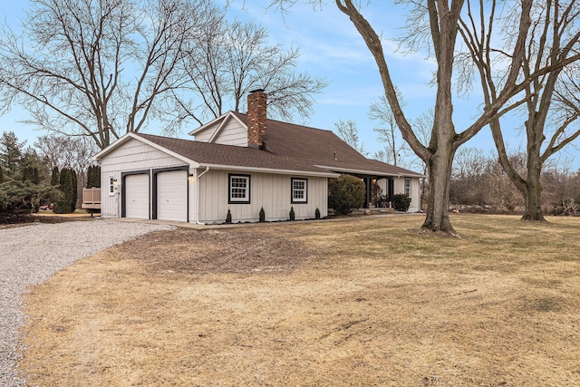 ranch-style home featuring a garage and a front lawn