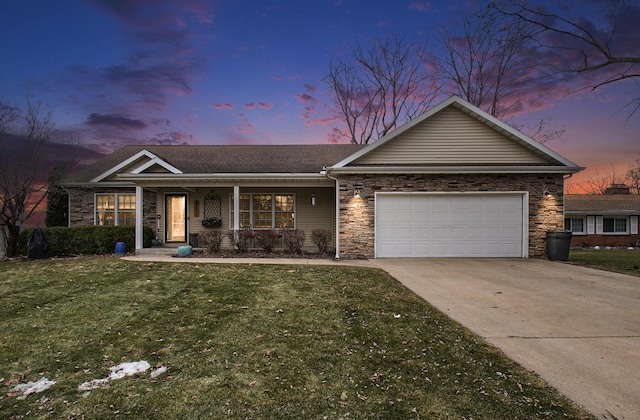 ranch-style home with a yard and a garage