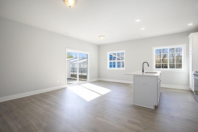 304 Ash St, South Haven, MI 49090 - kitchen with a healthy amount of sunlight, a kitchen island with sink, light countertops, and a sink