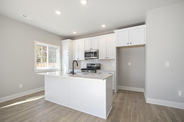 304 Ash St, South Haven, MI 49090 - kitchen featuring a kitchen island with sink, light wood-style flooring, appliances with stainless steel finishes, a sink, and visible vents