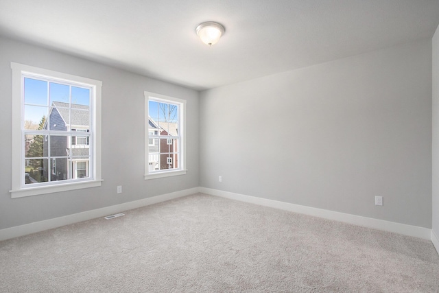 304 Ash St, South Haven, MI 49090 - spare room featuring light colored carpet, visible vents, and baseboards