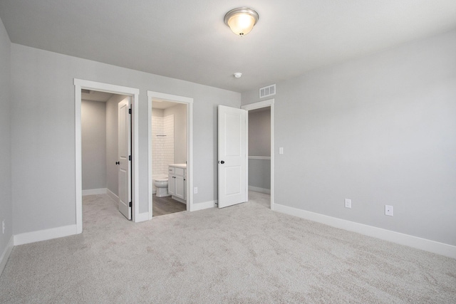 304 Ash St, South Haven, MI 49090 - unfurnished bedroom with visible vents, ensuite bath, light carpet, and baseboards