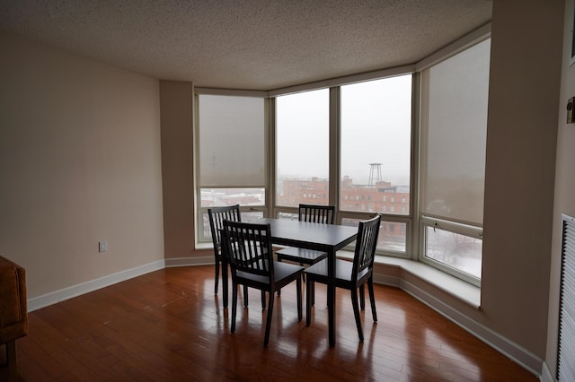 dining room featuring dark hardwood / wood-style floors and a textured ceiling