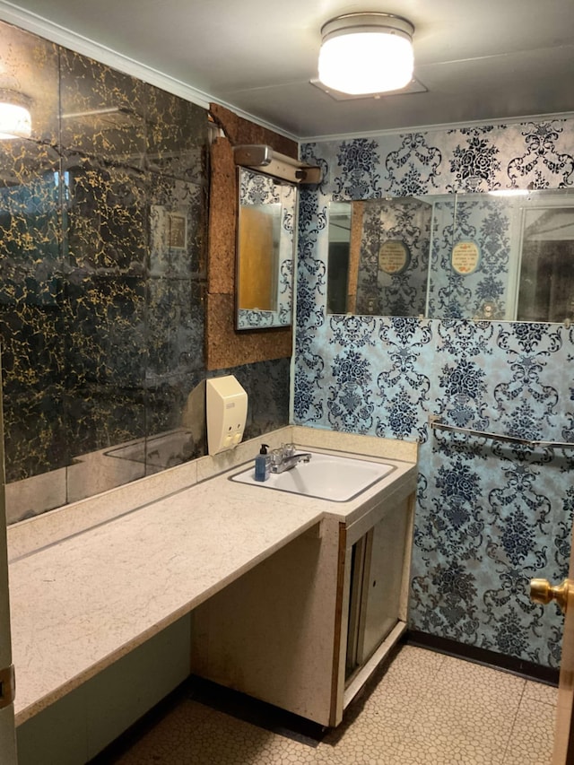 bathroom with crown molding and vanity