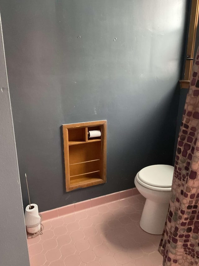 bathroom featuring toilet and tile patterned flooring