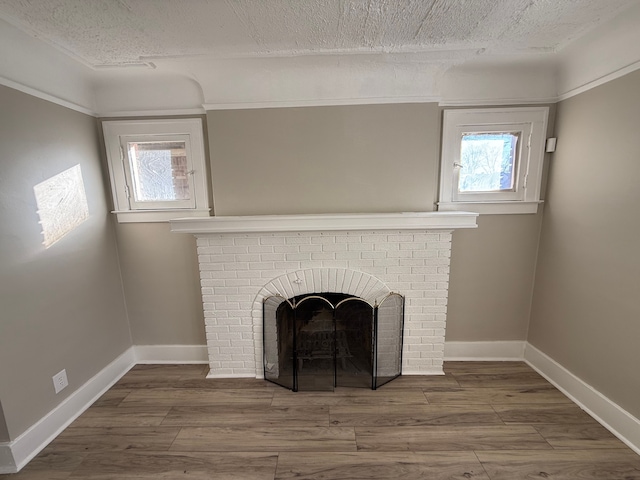 room details featuring hardwood / wood-style floors, a fireplace, and a textured ceiling