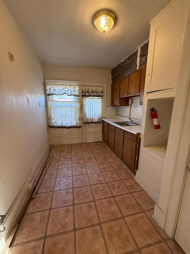 kitchen featuring sink and light tile patterned floors