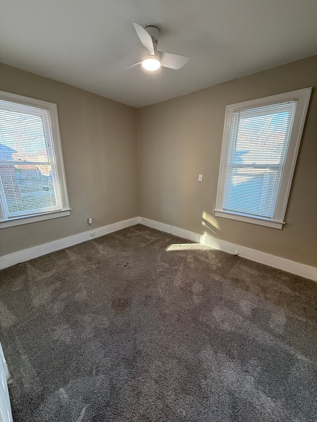 carpeted empty room featuring ceiling fan